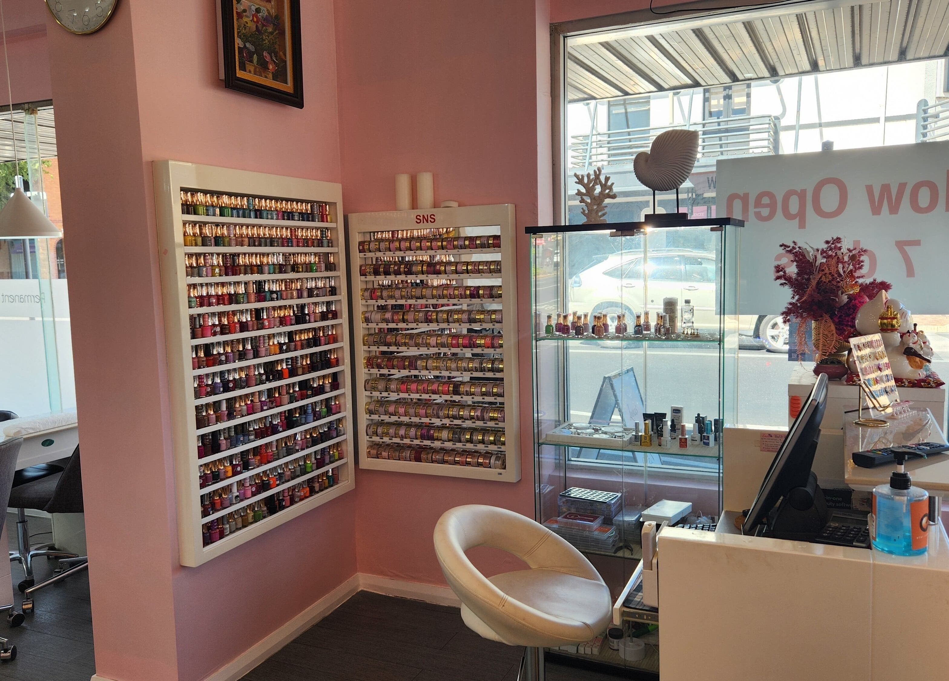 Inside Lunas Nails Palace, Walkerville, South Australia, showcasing colorful polish display and cozy seating.