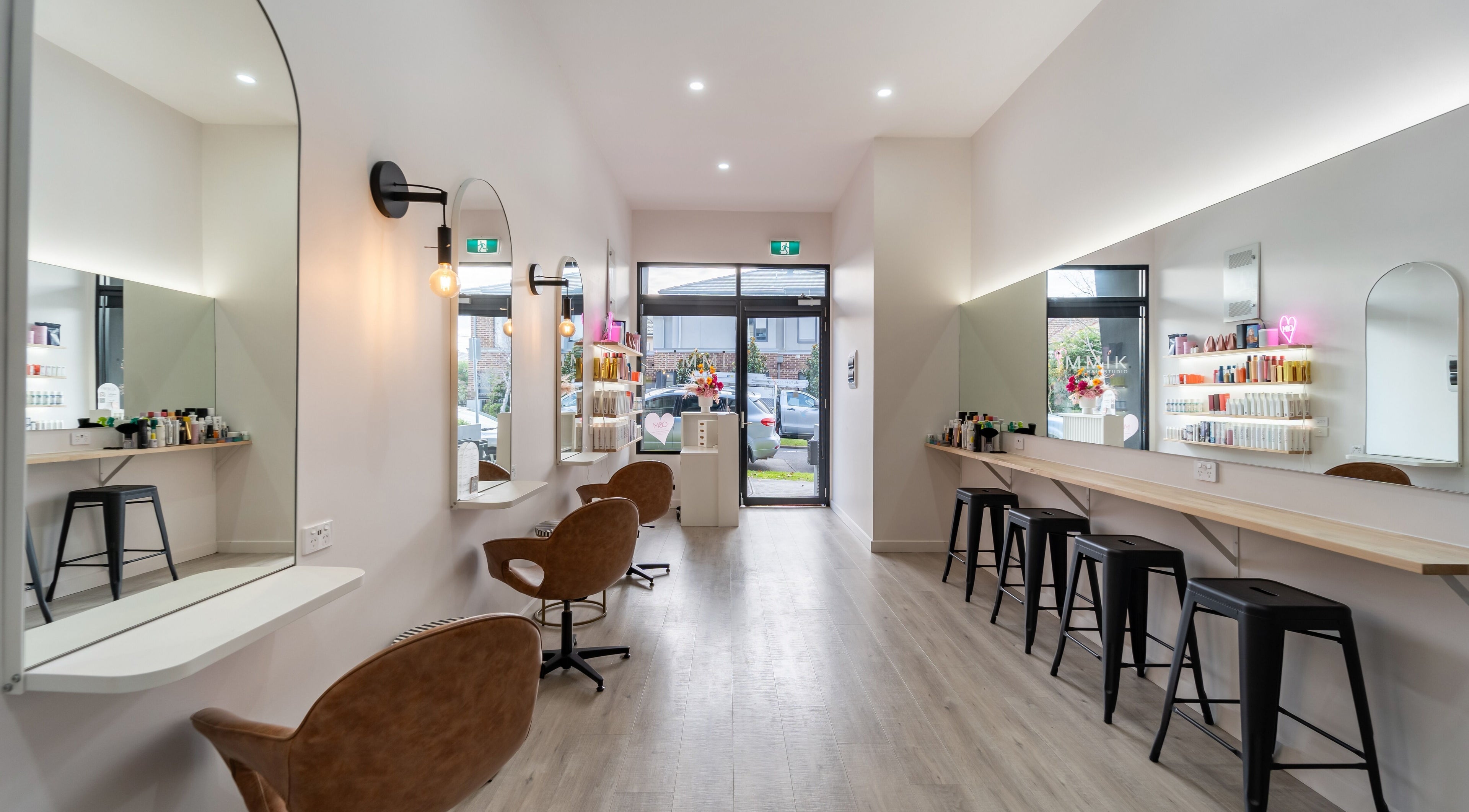 Modern interior of Immik Hair Studio in Melbourne, Victoria, AU showcasing stylish salon chairs and decor.