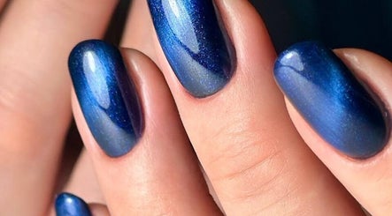 Elegant blue nails from ND Beauty Space in Hamilton, Ontario, CA showcasing shimmering nail art.