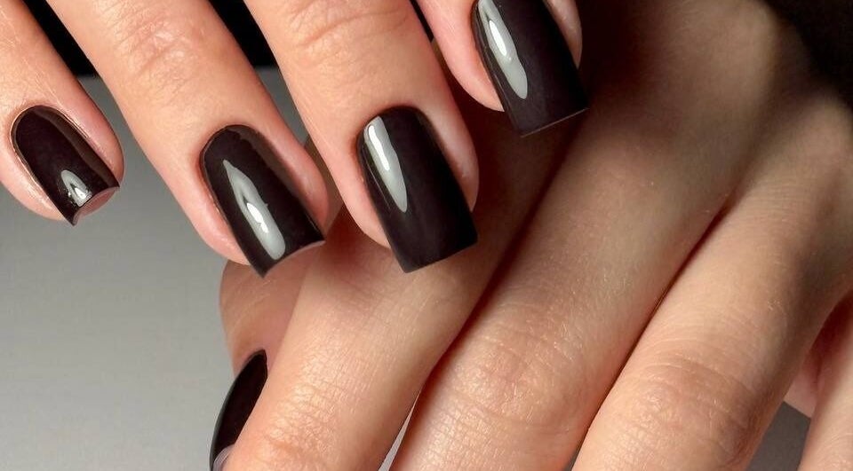 Elegant dark manicure at ND Beauty Space, Hamilton, Ontario, CA showcasing high-gloss finish.