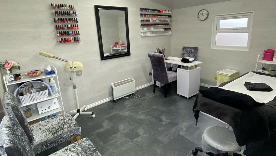 Elegant interior of Dee Beauty Salon in Eastleigh, England, GB with nail polish display and cozy seating.