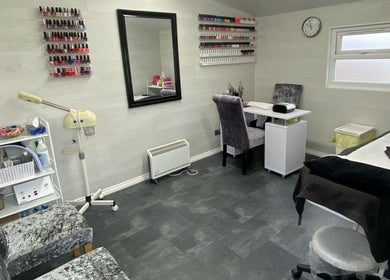 Elegant interior of Dee Beauty Salon in Eastleigh, England, GB with nail polish display and cozy seating.