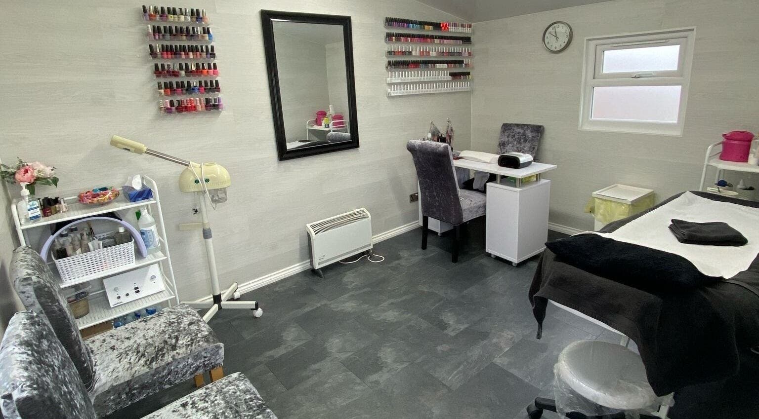 Elegant interior of Dee Beauty Salon in Eastleigh, England, GB with nail polish display and cozy seating.