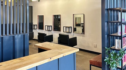 Chic salon interior at The Hair Company, Umhlanga, Kwazulu-Natal, ZA, showcasing modern styling stations.