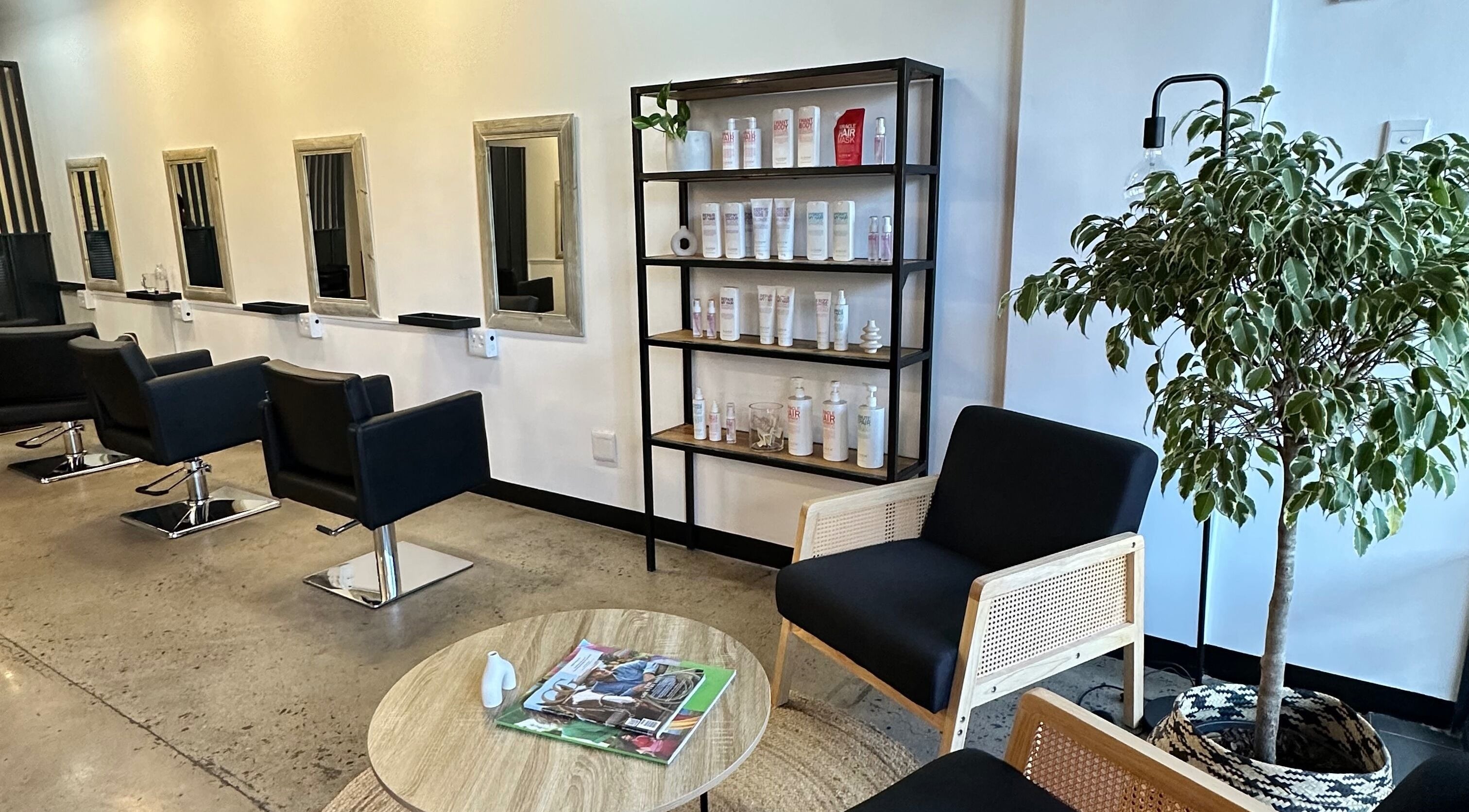 Modern salon interior at The Hair Company in Umhlanga, Kwazulu-natal, ZA, featuring stylish decor and products.