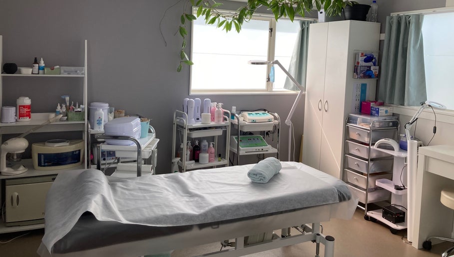 Bright, serene treatment room at SugaZap Studio, Auckland, Auckland, NZ, with massage table and skincare equipment.