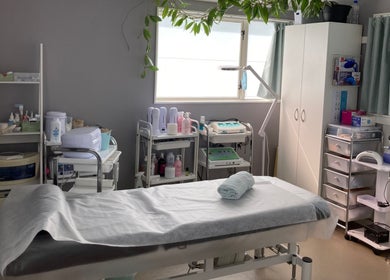 Bright, serene treatment room at SugaZap Studio, Auckland, Auckland, NZ, with massage table and skincare equipment.