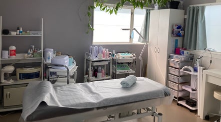 Bright, serene treatment room at SugaZap Studio, Auckland, Auckland, NZ, with massage table and skincare equipment.