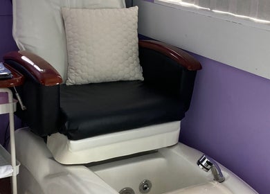 Luxurious pedicure chair at SugaZap Studio, Auckland, Auckland, NZ, with a cozy pillow and spa basin.