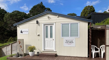 Exterior of Sugar Waxing & Beauty Studio in Auckland, NZ, featuring a cozy entrance and lush surroundings.