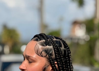 Intricate braided hairstyle at SlayedbyKy, Brighton, St. George, VC showcasing creative beauty.