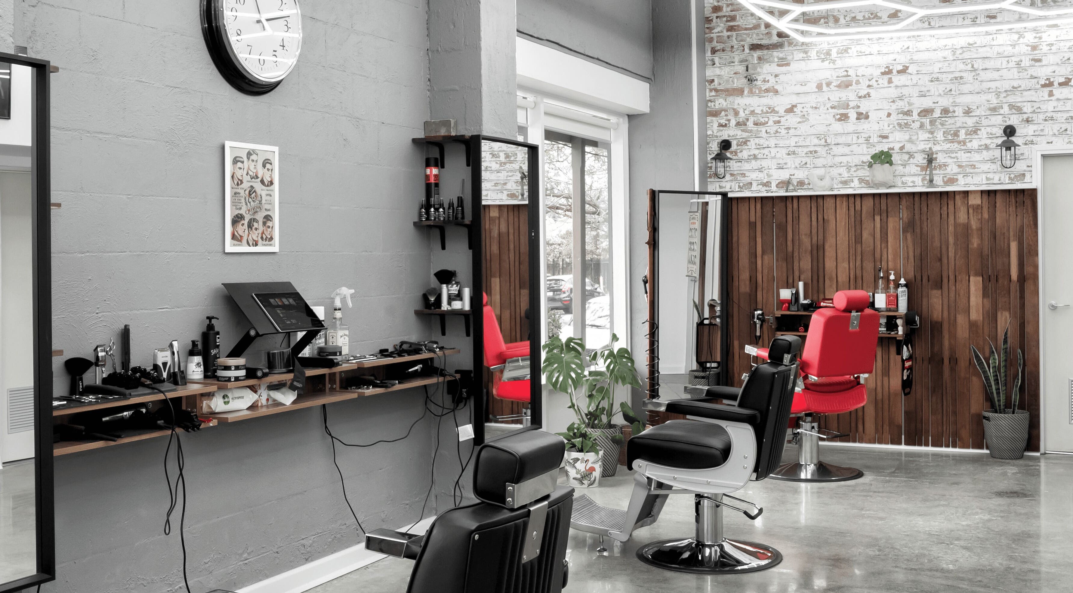 Modern barber chairs in Republic Of Barbers, Malvern, South Australia, AU with sleek decor and styling tools.