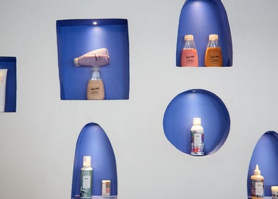 Chad Wij salon displays premium beauty products in a modern blue niche, Newtown, New South Wales, AU.