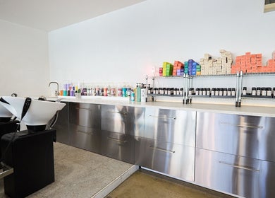 Modern salon interior at Chad Wij, Newtown, New South Wales, AU, featuring sleek stations and vibrant products.