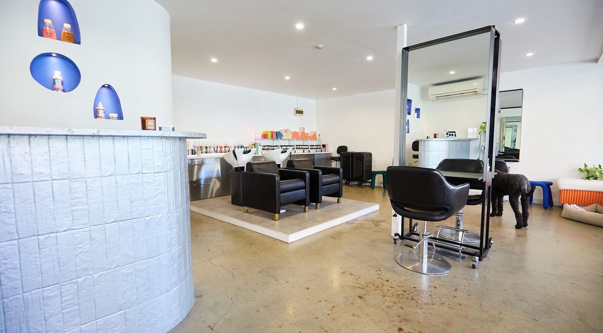 Modern salon interior at Chad Wij, Newtown, New South Wales, AU, featuring sleek chairs and styling stations.