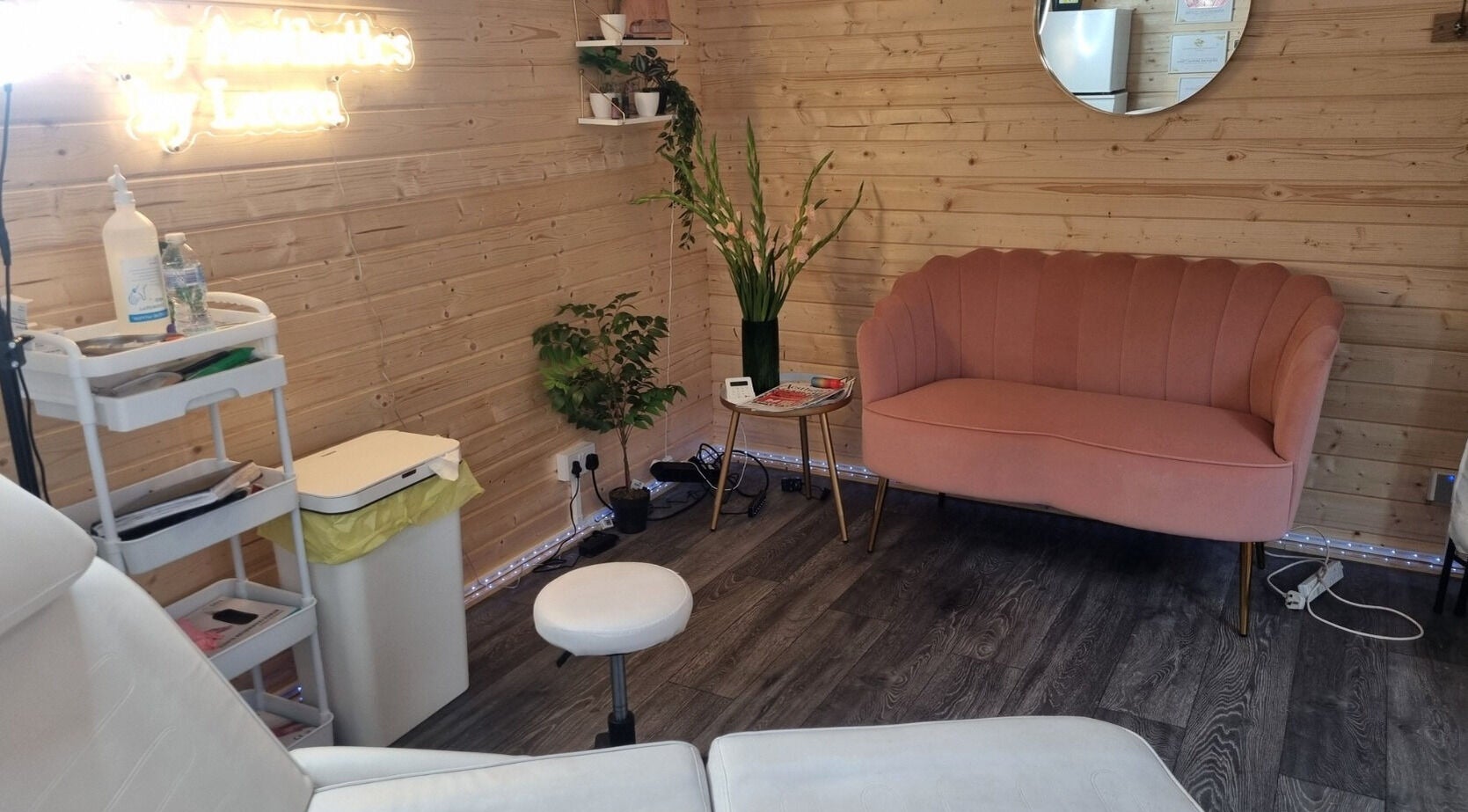 Lovely Aesthetics by Laura in Epsom, England, GB, featuring a chic pink sofa and serene decor.