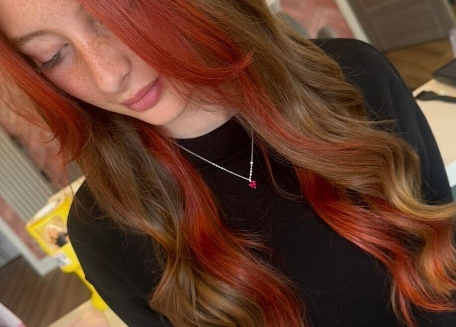 Stylish hair coloring at STUDIO 68 Hair & Nails in Portsmouth, England, GB. Showcasing vibrant red and brown waves.