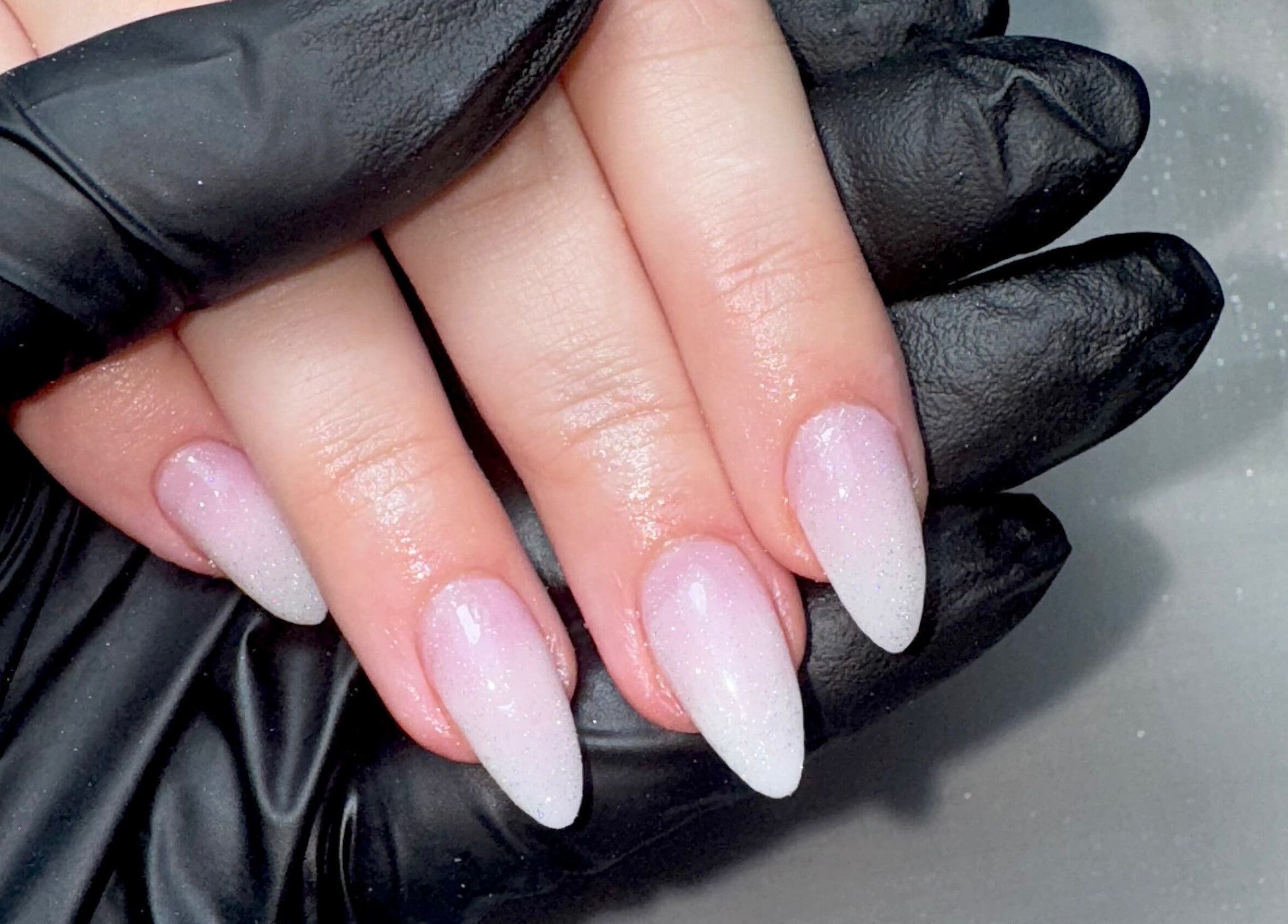 Elegant stiletto nails at STUDIO 68 Hair & Nails, Portsmouth, England, GB, showcasing flawless pink and white ombre.