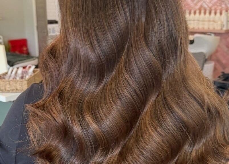 Lustrous wavy hairstyle at STUDIO 68 Hair & Nails in Portsmouth, England, GB, highlighting expert styling.