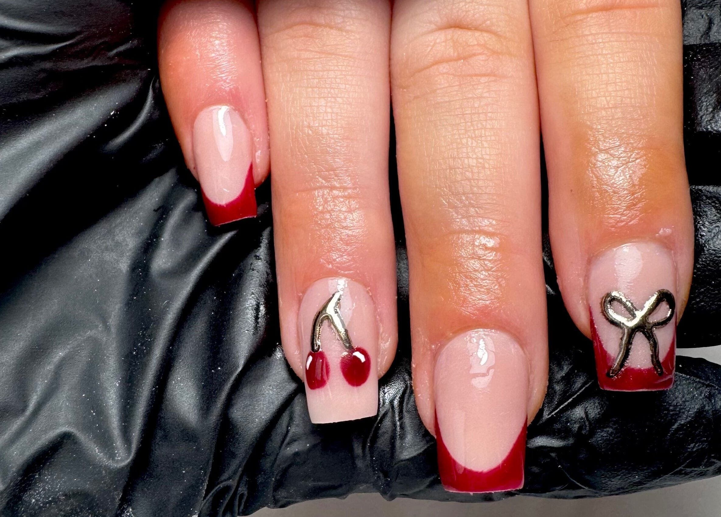 Stylish cherry-themed nail art at STUDIO 68 Hair & Nails, Portsmouth, England, GB.