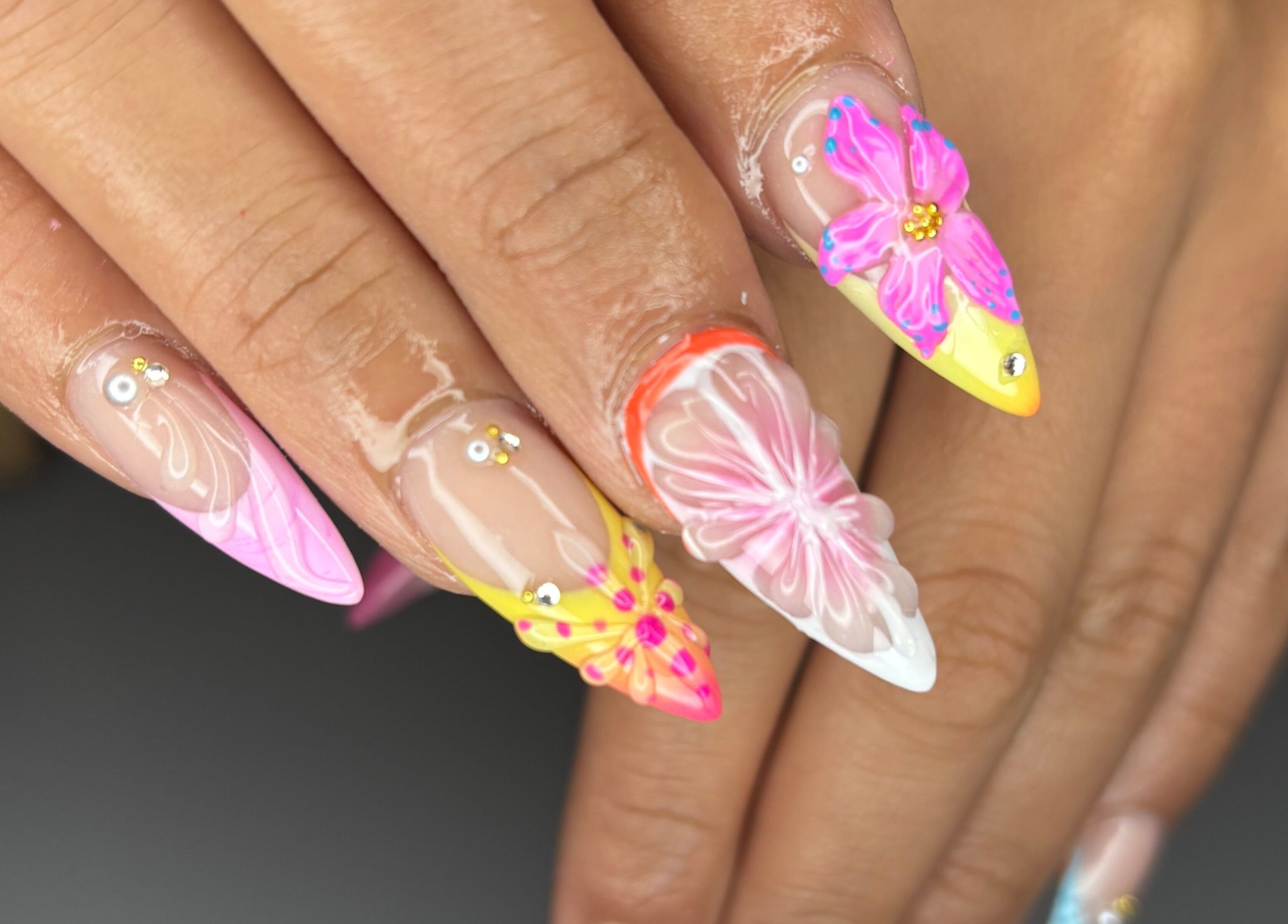 Vibrant floral nail art design by Designed by Ry, Toronto, Ontario, CA, showcasing detailed petals.