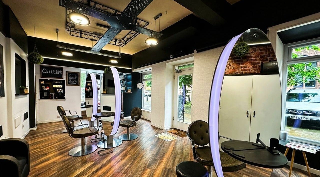 Modern interior of POMOhair in Glasgow, Scotland, GB, featuring stylish seating and a coffee bar.