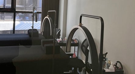 Interior of Afia Beauty Studio in Randburg, Gauteng, ZA with massage tables and spa equipment under warm lighting.