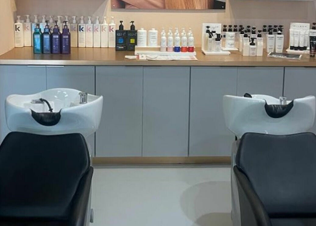 Sleek wash stations at Boudoir hair concepts in Plano, Texas, US, with quality hair products displayed.