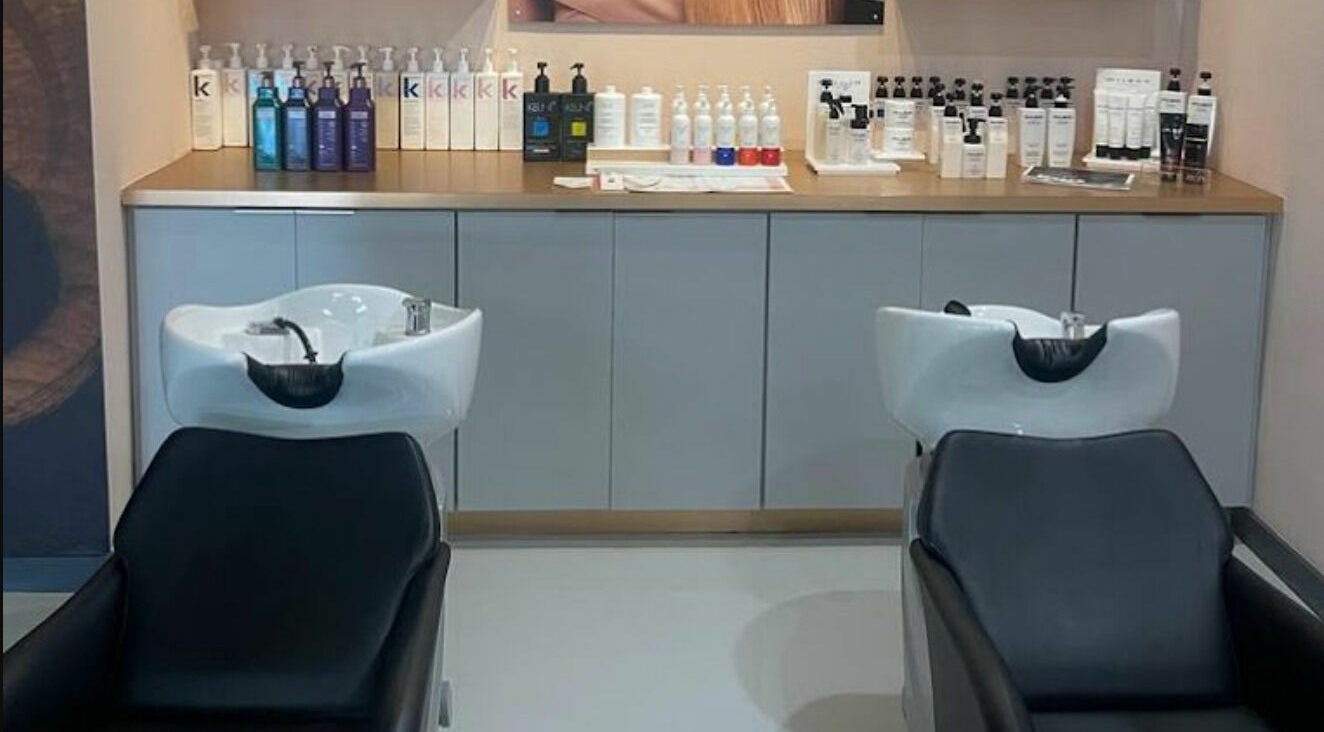 Sleek wash stations at Boudoir hair concepts in Plano, Texas, US, with quality hair products displayed.