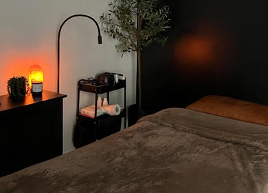 Tranquil therapy room at Cloud Nine Beauty Studio in Tillsonburg, Ontario, CA, showcasing a cozy massage bed.