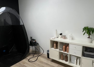 Modern spray tan booth and sleek shelving at Cloud Nine Beauty Studio in Tillsonburg, Ontario, CA.
