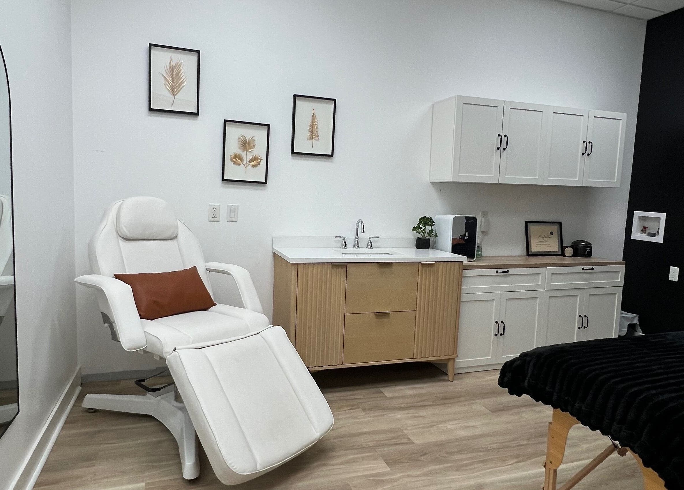 Elegant spa room at Cloud Nine Beauty Studio, Tillsonburg, Ontario, CA featuring a plush white chair and modern decor.