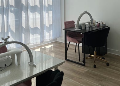 Nail station at Cloud Nine Beauty Studio, Tillsonburg, Ontario, CA, with elegant chairs and manicure setup.