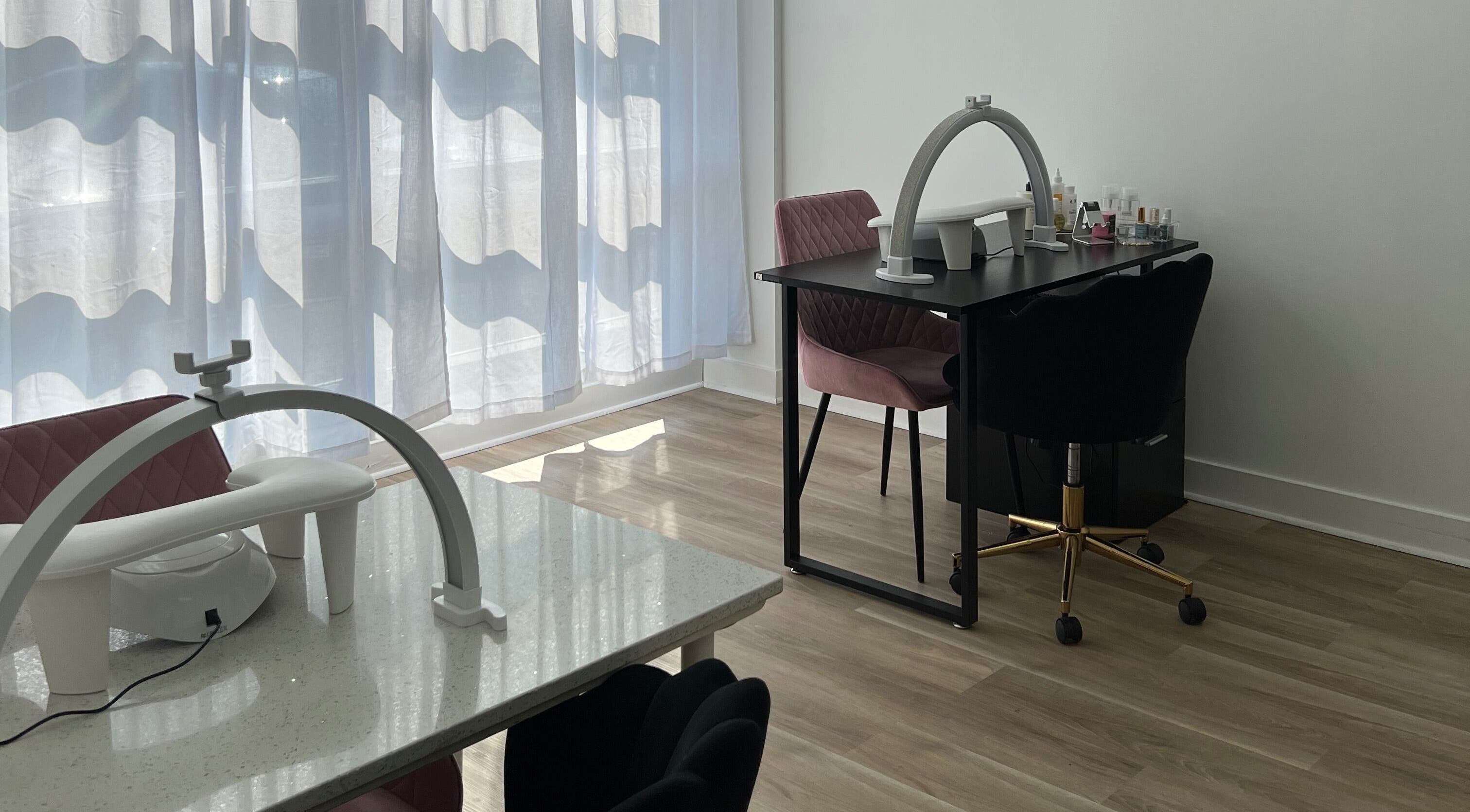 Nail station at Cloud Nine Beauty Studio, Tillsonburg, Ontario, CA, with elegant chairs and manicure setup.