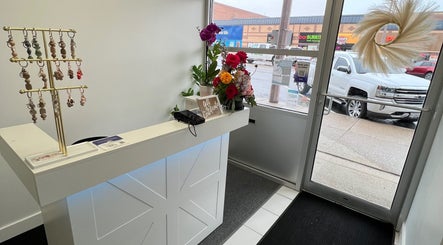 Reception area at Cloud Nine Beauty Studio in Tillsonburg, Ontario, CA with floral decor and keychains.