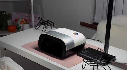 Sleek nail station at On The Lash in Londonderry, Northern Ireland, GB with UV lamp and modern decor.