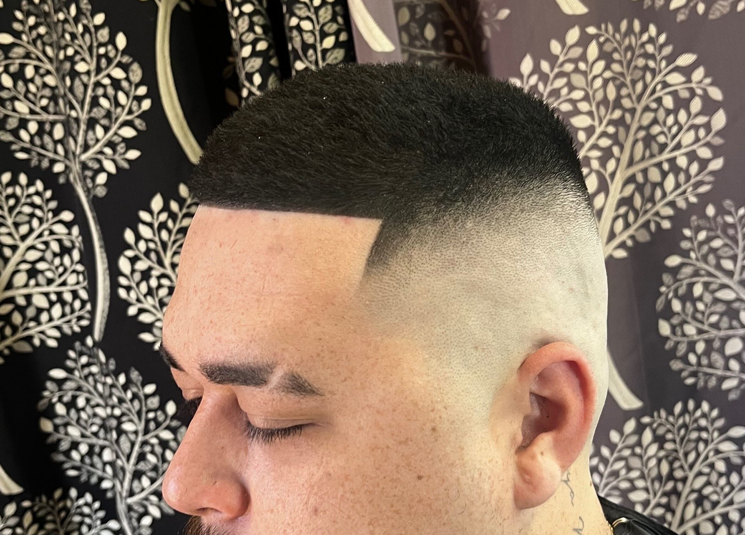 Sharp fade haircut at Jack’s Barber Style, Wodonga, Victoria, AU with detailed design backdrop.