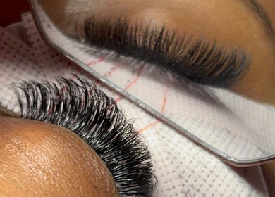 Close-up of lush eyelash extensions at The Hotspot, Longdenville, Chaguanas, TT, reflecting in a mirror.