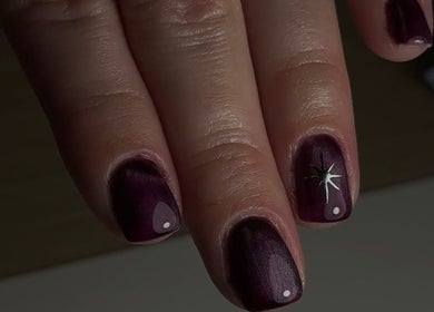 Elegant dark nails with a star design at Bonnie Beauty, Bomaderry, New South Wales, AU.