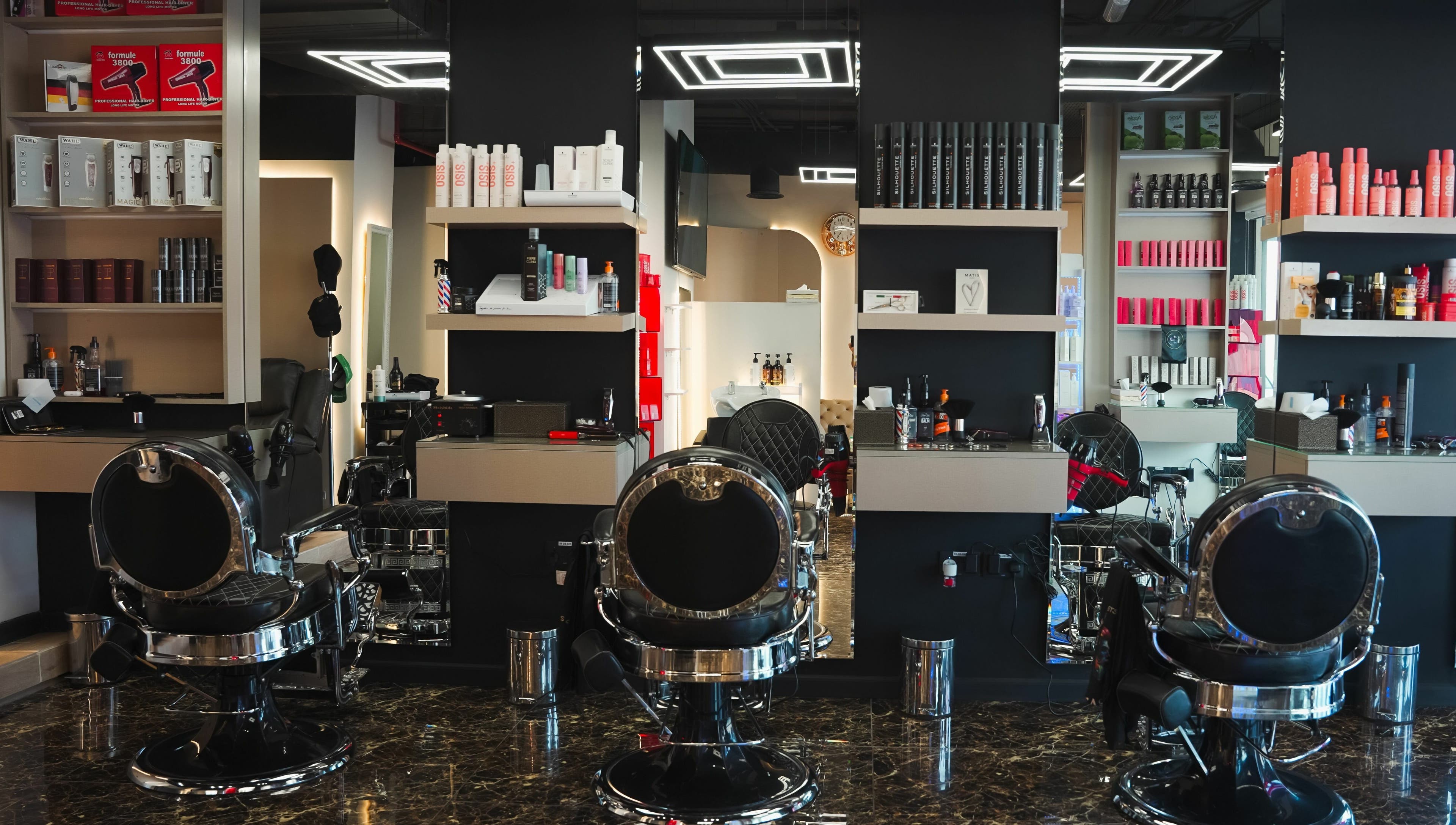 Modern interior of Picasso Touch Salon For Gents in Abu Dhabi, AE showcasing sleek styling chairs and products.