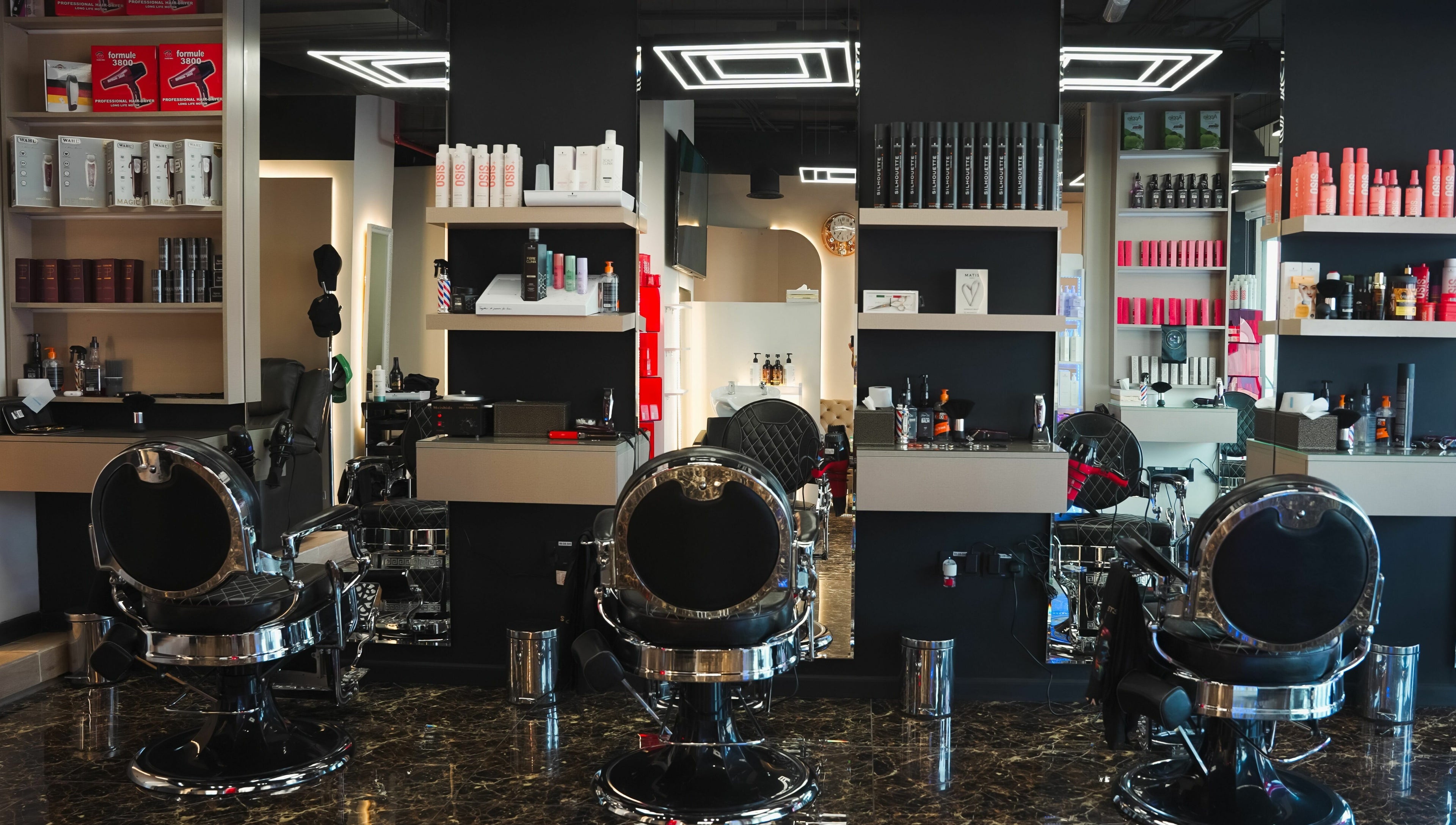 Modern interior of Picasso Touch Salon For Gents in Abu Dhabi, AE showcasing sleek styling chairs and products.