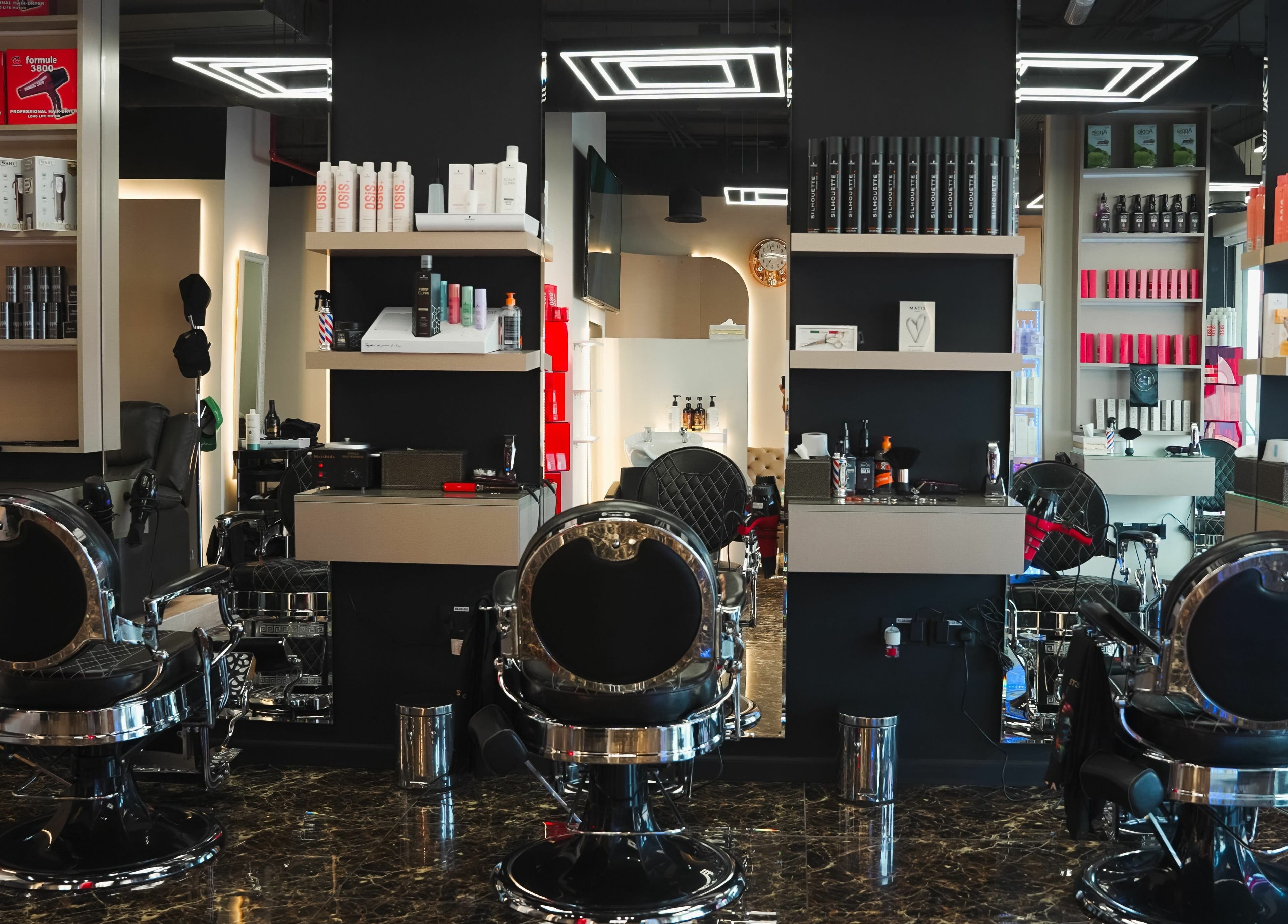Modern interior of Picasso Touch Salon For Gents in Abu Dhabi, AE showcasing sleek styling chairs and products.
