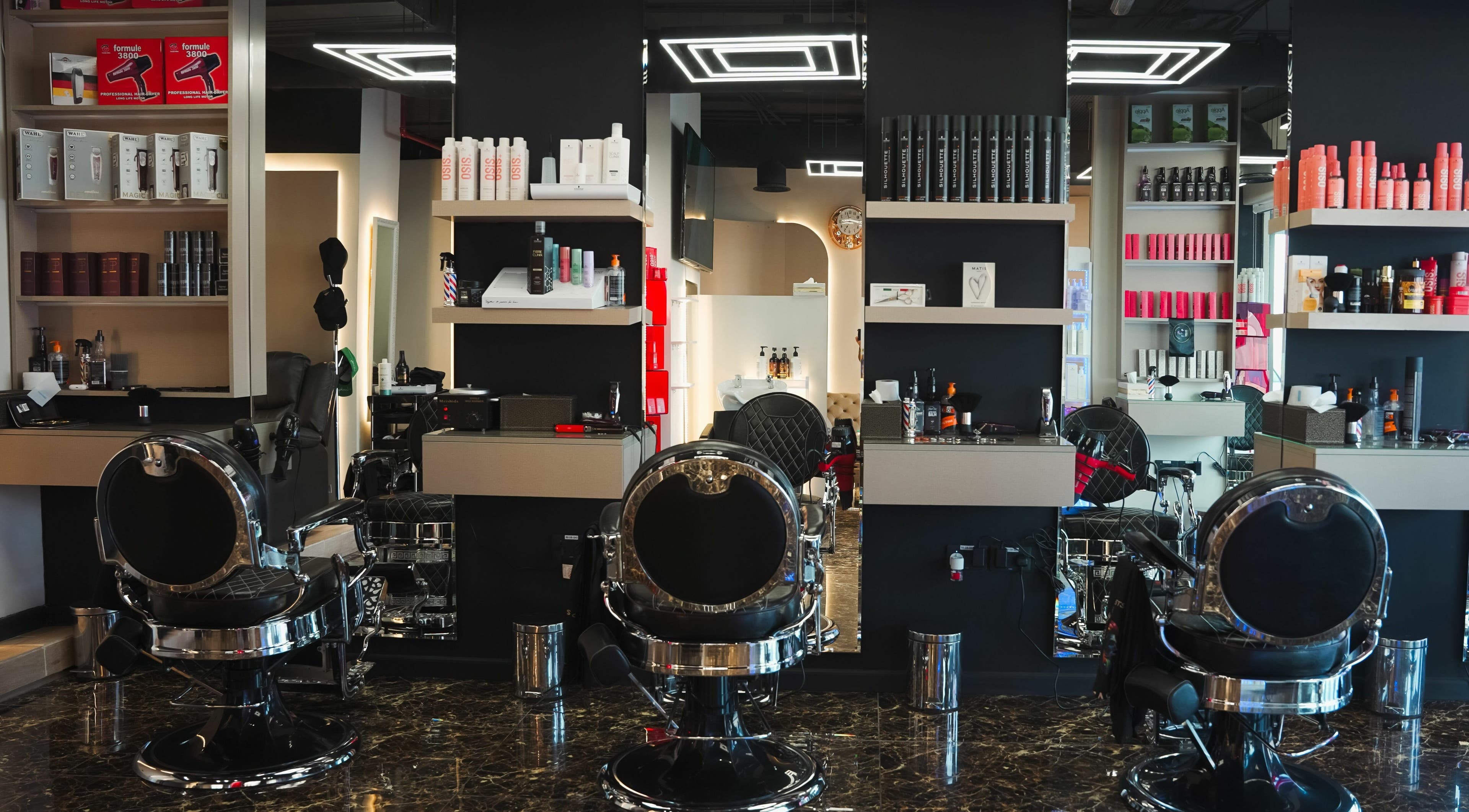 Modern interior of Picasso Touch Salon For Gents in Abu Dhabi, AE showcasing sleek styling chairs and products.