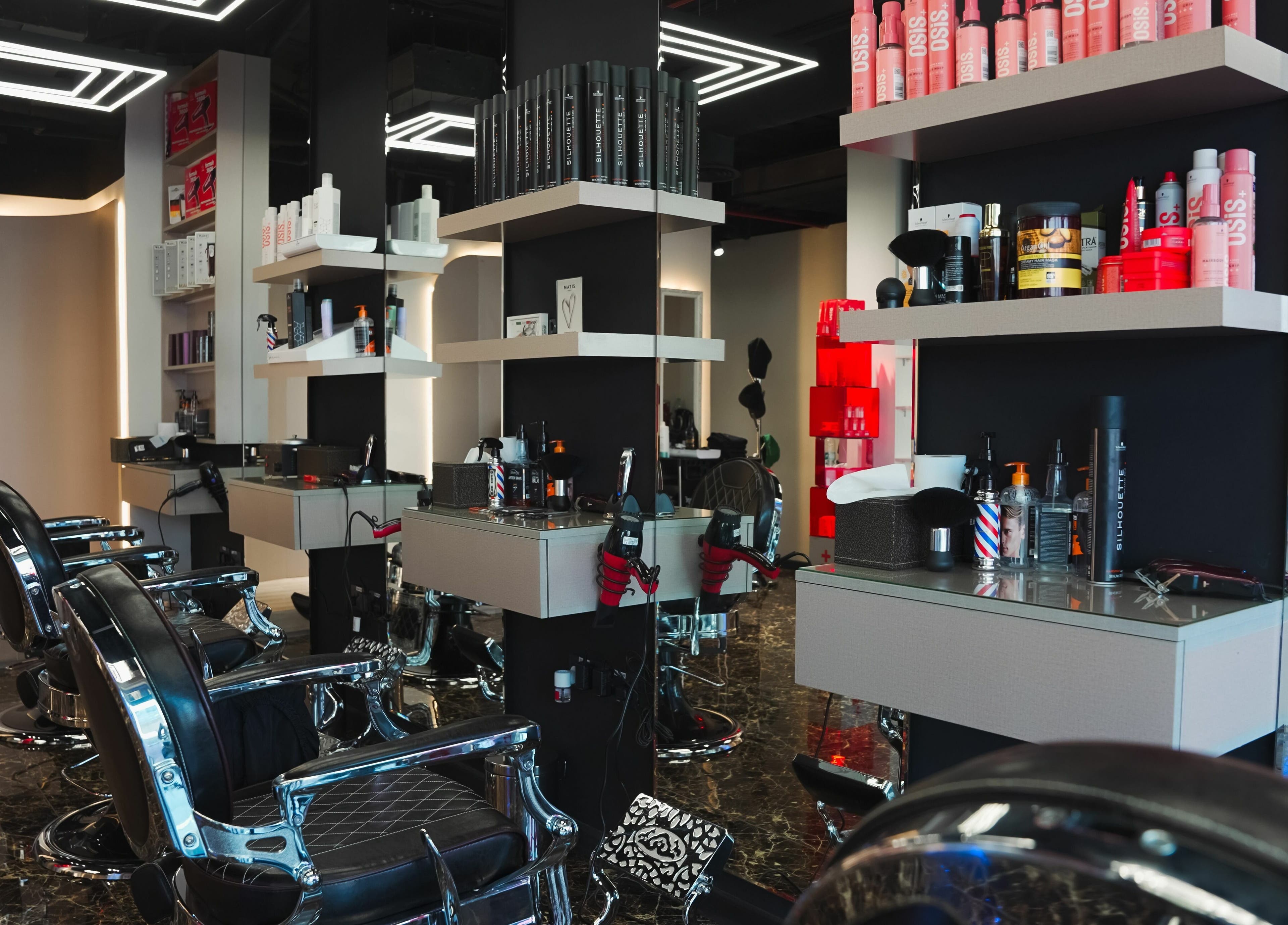 Elegant interior of Picasso Touch Salon For Gents, Abu Dhabi, AE showcasing modern barber chairs and sleek design.