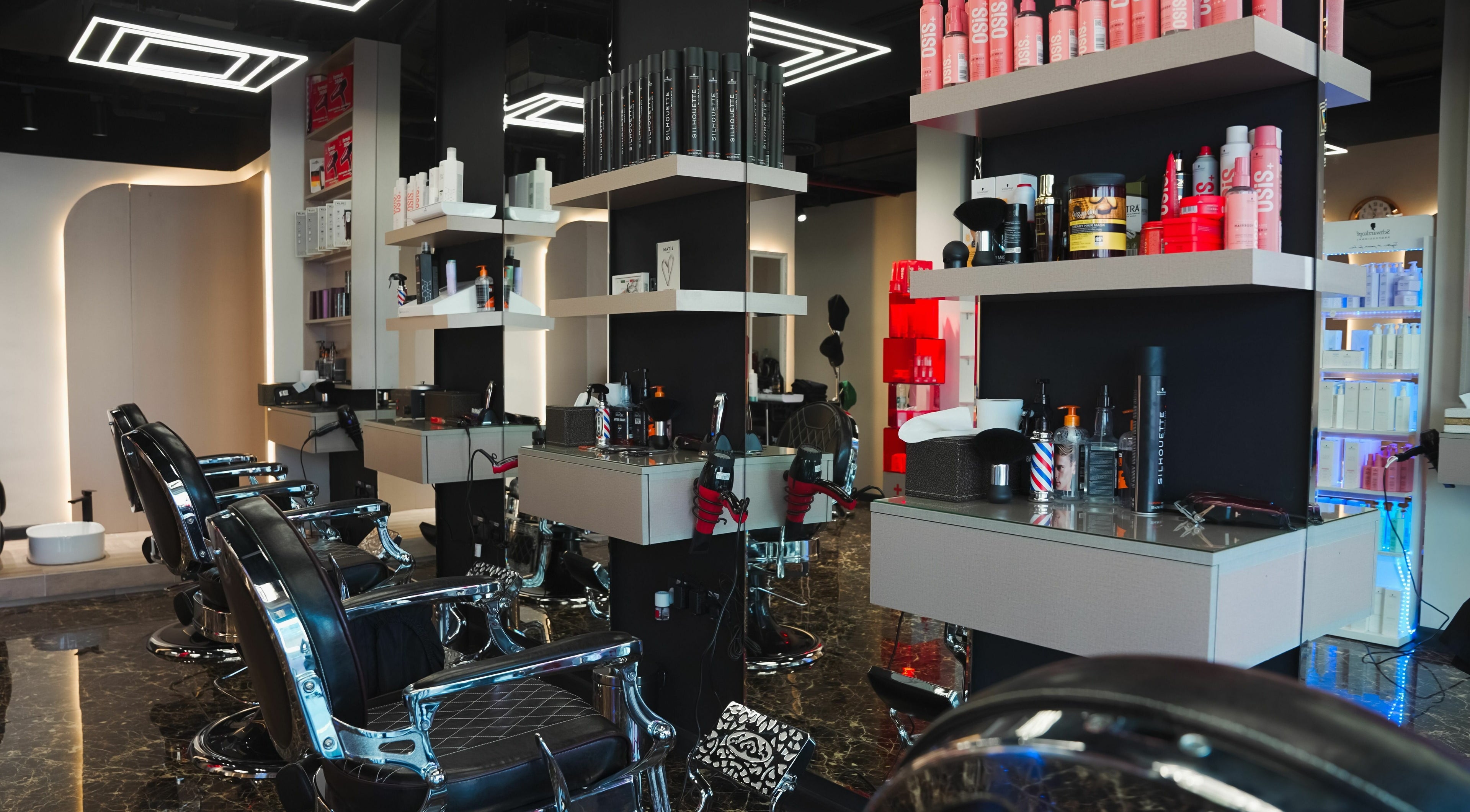 Elegant interior of Picasso Touch Salon For Gents, Abu Dhabi, AE showcasing modern barber chairs and sleek design.