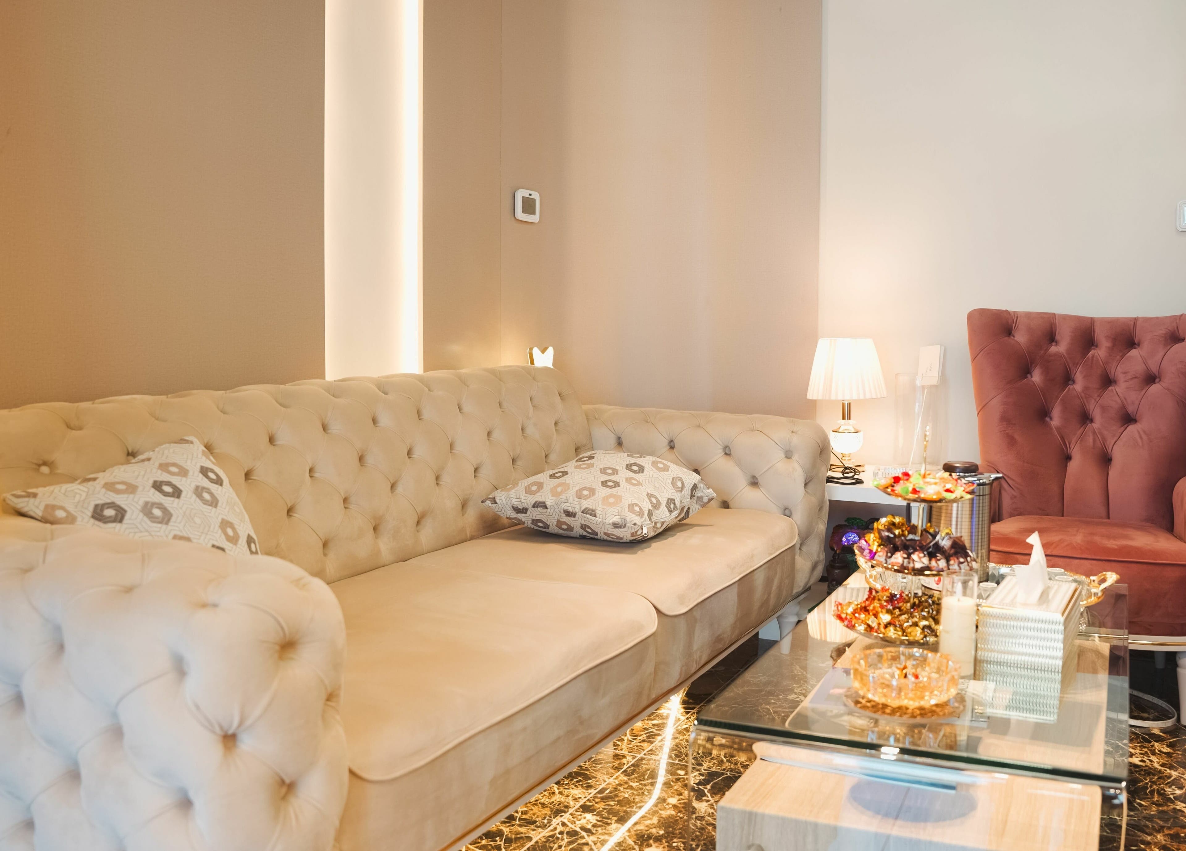 Elegant lounge area at Picasso Touch Salon For Gents, Abu Dhabi, AE featuring plush sofas and chic decor.