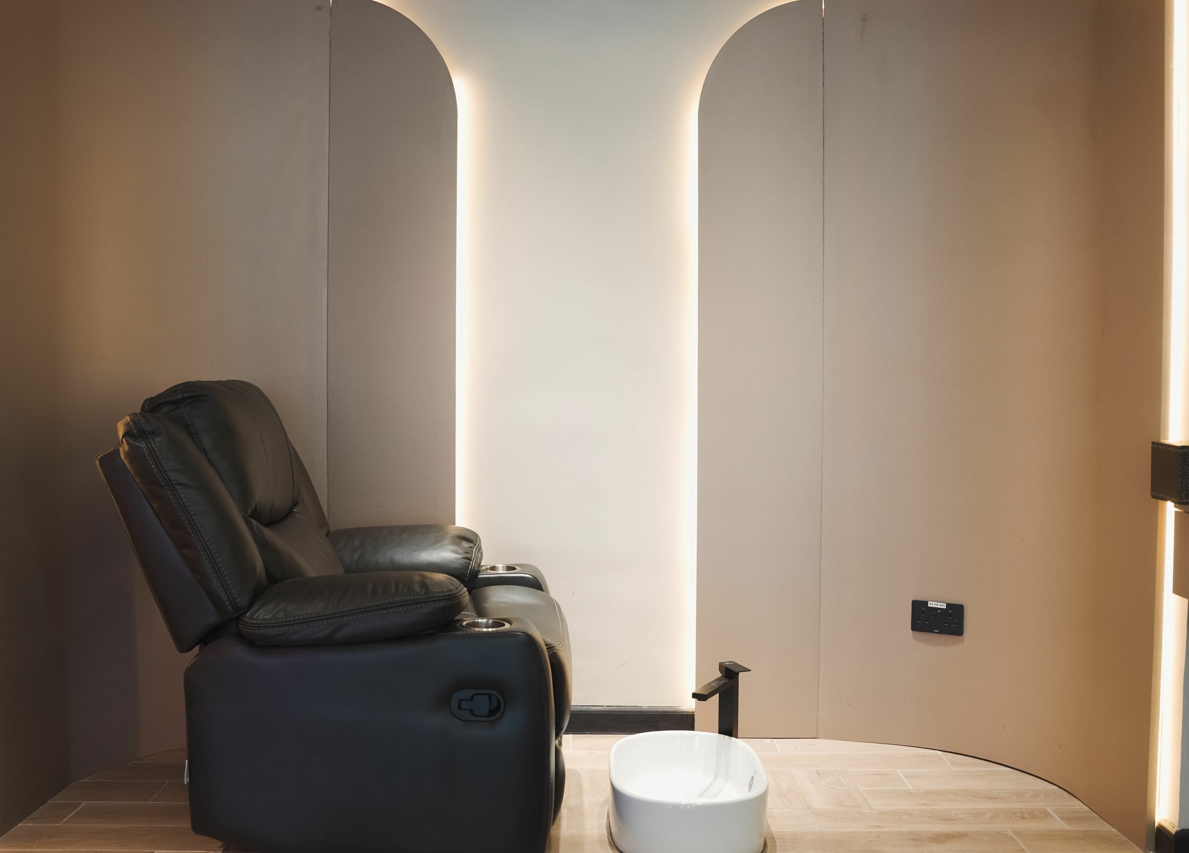 Luxurious reclining chair in Picasso Touch Salon For Gents, Abu Dhabi, AE offers premium comfort.