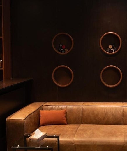 Elegant lounge at Bros Salon Qatif, Al Qatif, Eastern Province, SA with leather sofa and stylish decor.