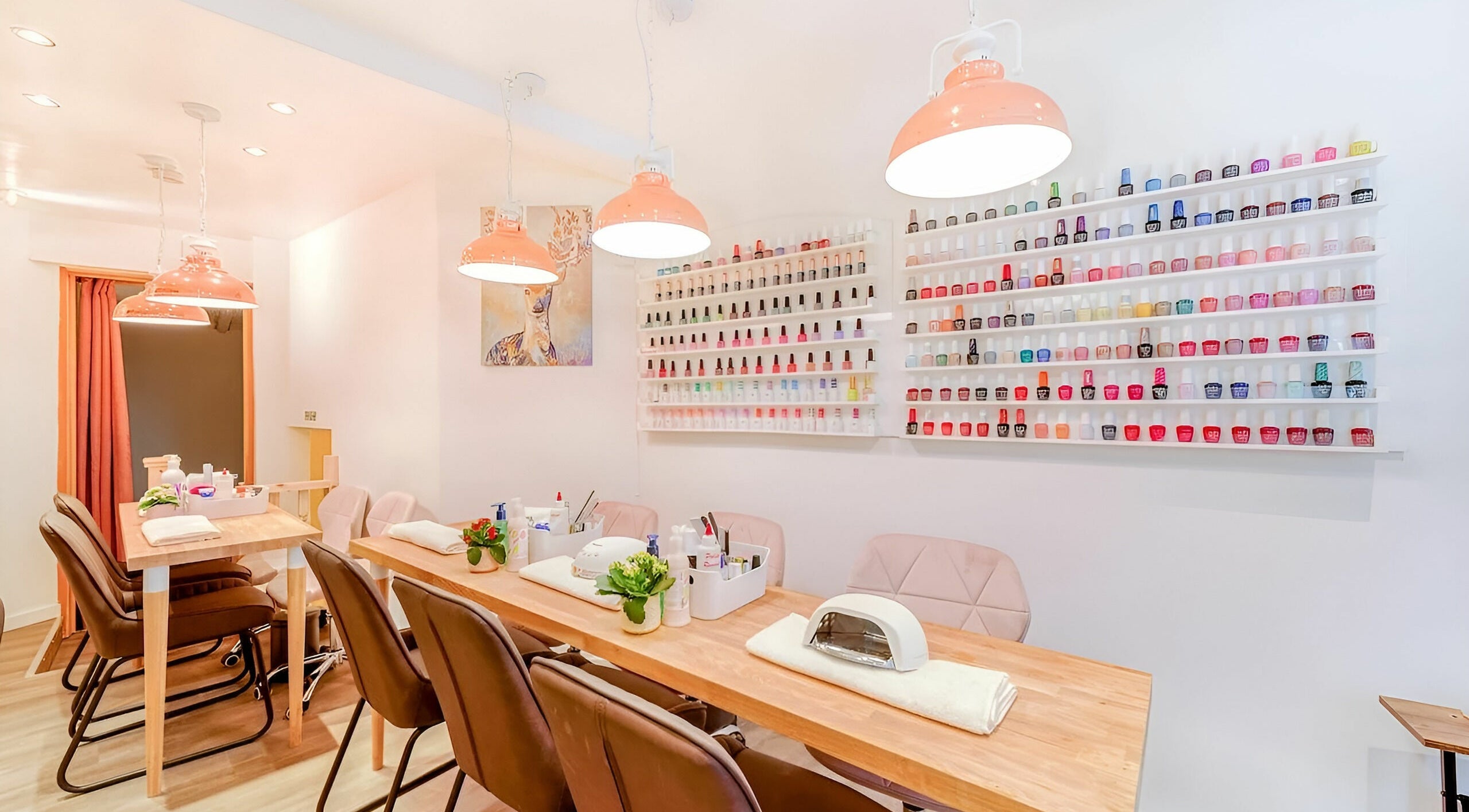 Elegant interior of The Nail Garden Leicester Square, London, England, GB, showcasing a vibrant nail polish display.