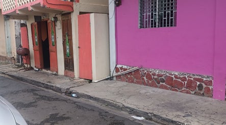 Colorful storefront near Merl's Beauty Section at Roseau, Saint George Parish, DM.